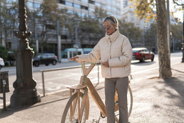 Woman with eco bike on sidewalk