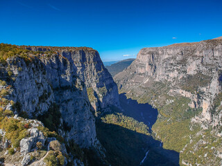 Aerial panoramic view of the impressive Vikos gorge in the Zagoria region at Pindus Mountains of northern Greece. It lies on the southern slopes of Mount Tymfi and it is the the deepest in Europe.