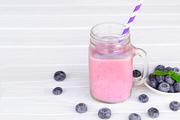 Blueberry Juice smoothies drink in a glass drink purple colorful fruit juice milkshake blend beverage healthy high protein the taste yummy in glass on white wood background.