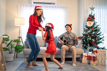 Asian lovely family member enjoy sing Christmas song together at home.