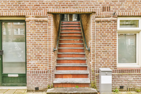 Staircase Leading Upstairs In A Brick Building