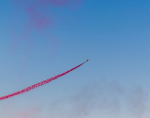 Military airplane performing stunts in clear blue sky. Airshow
