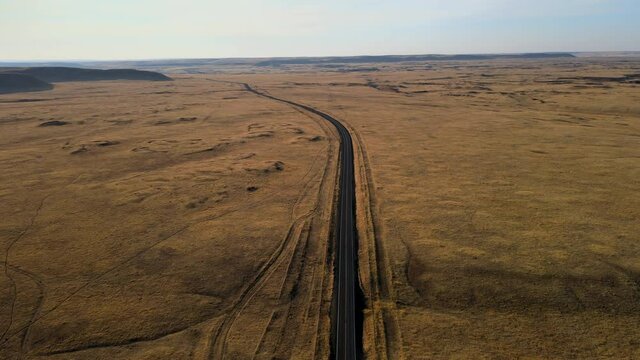 North American road leading toward golden plains
