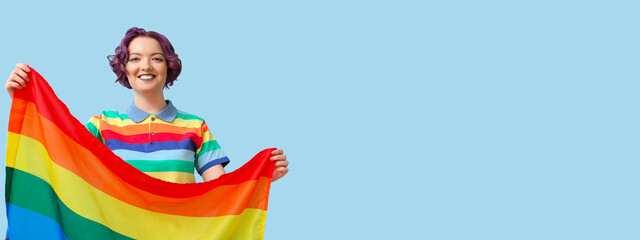 Young woman with LGBT flag on blue background with space for text