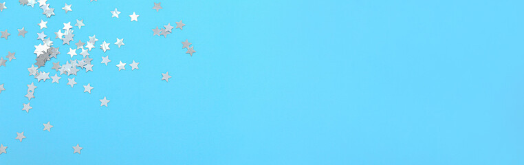 Beautiful confetti on blue background with space for text