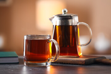 Glass cup of tasty tea on table in cafe