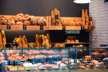 Bakery shop with assortment of bread on shelves. High quality photo