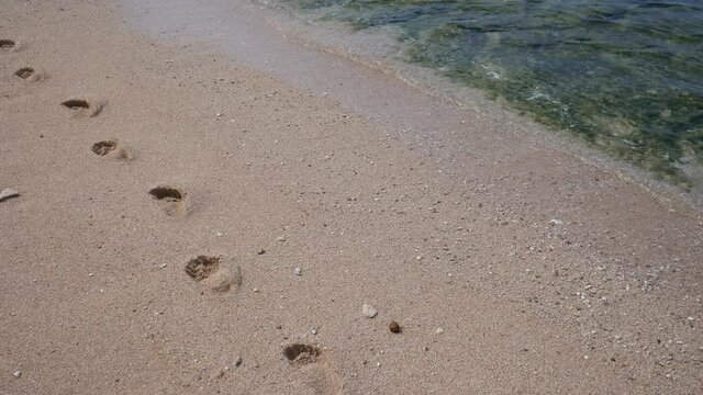 Footprint on the white sand on the beach