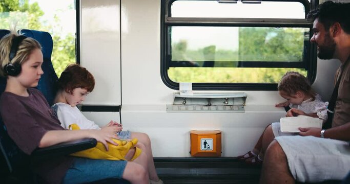 Family With Kids Travelling By Suburban Train. Using Public Transport