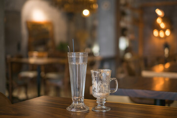 Two empty iced coffee glass cups on the table in coffee shop. High quality photo