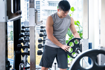 Easy to use training gym material, barbells being prepared.