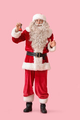 Santa Claus with Christmas bell on pink background