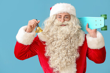 Santa Claus with Christmas bell and skateboard on blue background