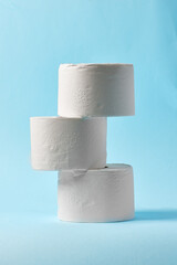 White toilet paper on blue color background. Toilet paper article. Textures on cotton paper.