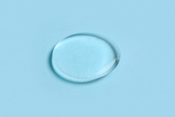 Drop of liquid transparent gel on blue background