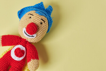 Handmade toy with yarn thread. Plim plim toy on color background