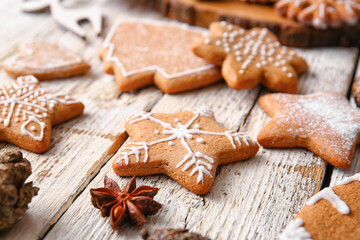 Fototapeta na wymiar Delicious gingerbread cookies on light wooden background, closeup