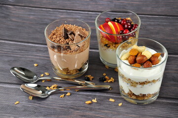 Healthy breakfast homemade muesli in glasses on a wooden background