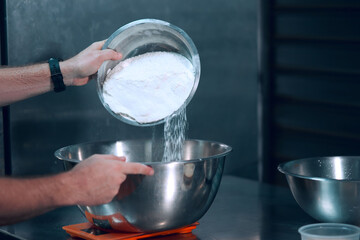 Bowl with pizza flour poured and mixed by chef at a restaurant