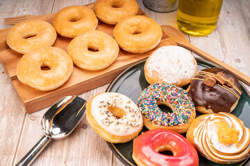 Mixed donuts, original flavor, chocolate, marmalade and fancy toppings on wooden background.