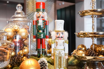 Nutcracker. Vintage wooden nut crackers for festive season during Christmas and New Year with selective focus on the Nutcracker in the white uniform.