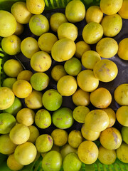Fresh organic lemons kept together in a stall of a retail market