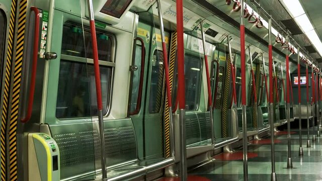 Empty interior of Hong Kong MTR subway train during commute.