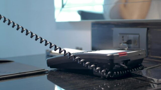 POV to telephone while using hand answer telephone when working from home