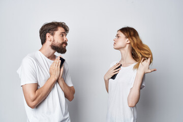 a young couple family with phones in hand communication isolated background