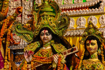 Statue of Goddess Saraswati holding a musical Instrument called Veena, clicked during Dussehra festival Kolkata, West Bengal, India.