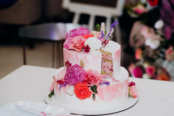 Wedding cake bride and groom with pink peonies