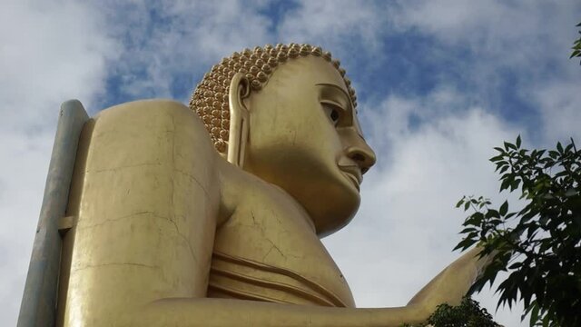 Close-up view of the goddess Buddha's big golden painted statue at Dambulla cave temple in Sri Lanka in a natural background.