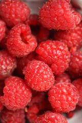 Many fresh raw raspberries filling the frame, macro