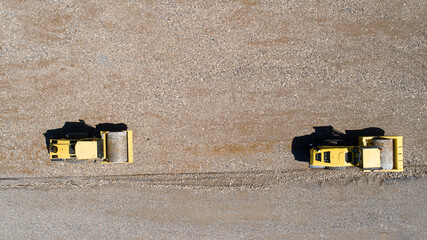 Aerial road building. Two rollers work making new road. construction site with road roller.