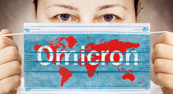 Face mask in hand with world map. Covid 19 alpha, beta, gamma, delta, lambda, mu, omicron variants outbreak around the world.