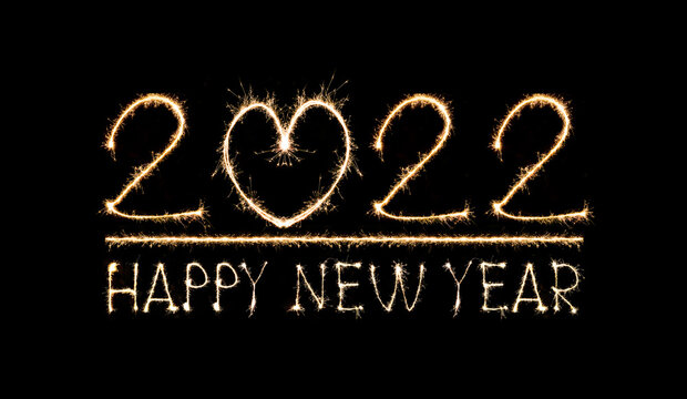 Happy New Year 2022 text hand written sparkles fireworks with Colorful fireworks of various colors at night