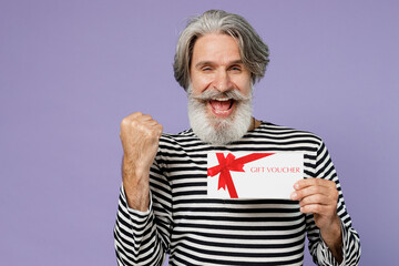 Elderly happy gray-haired mustache bearded man 50s wearing striped turtleneck hold gift certificate...