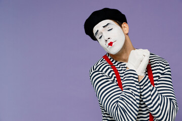 Dreamful fun sweet kind young mime man with white face mask wears striped shirt beret eyes closed ask who me oh it so sweet put hands on chest on plain pastel light violet background studio portrait.