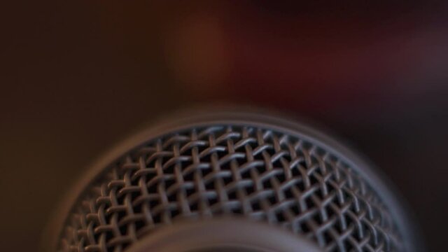 4K footage of a microphone and the silhouette of a beatboxing mouth in the background.