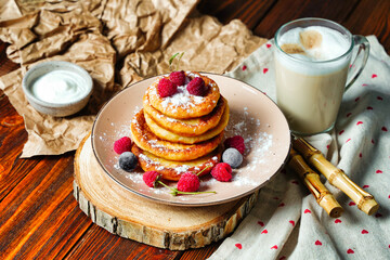 Cottage cheese pancakes, Syrniki with fresh mint. Pancakes with cottage cheese on a brown plate, Homemade food