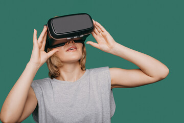 Caucasian woman wearing virtual reality device over green background. Close-up portrait