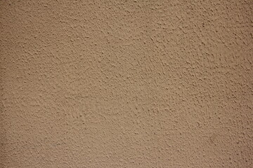 Old brown painted plastered concrete stone wall with background texture