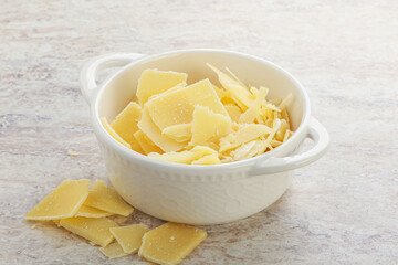 Sliced parmesan cheese heap in the bowl
