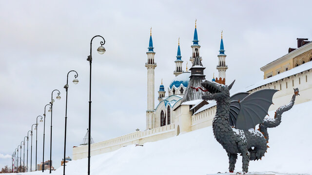 Metal sculpture of Zilant, the official symbol of Kazan. Winter view at the Kazan Kremlin wall and Kul Sharif mosque. Tatarstan, Russia