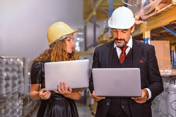 Manager and supervisor discussing work with products in stock and ready to delivery. 