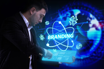 Business, Technology, Internet and network concept. Young businessman working on a virtual screen of the future and sees the inscription: Branding