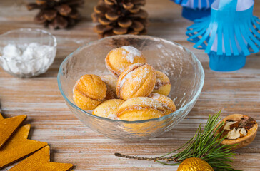 Shortbread cookies nuts stuffed boiled condensed milk in a glass bowl on a wooden background in the New Year's style. Cookies recipe.