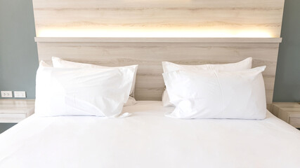 Selective focus of white pillows on the bedroom on a bed with duvet case bedspread isolated on white background