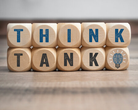 Cubes, dice or blocks with with message think tnk with brain light bulb on wooden background