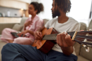 Blur of black couple play on musical instruments